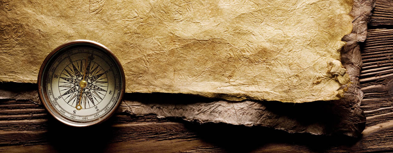 Close up view of the Compass on the old paper background